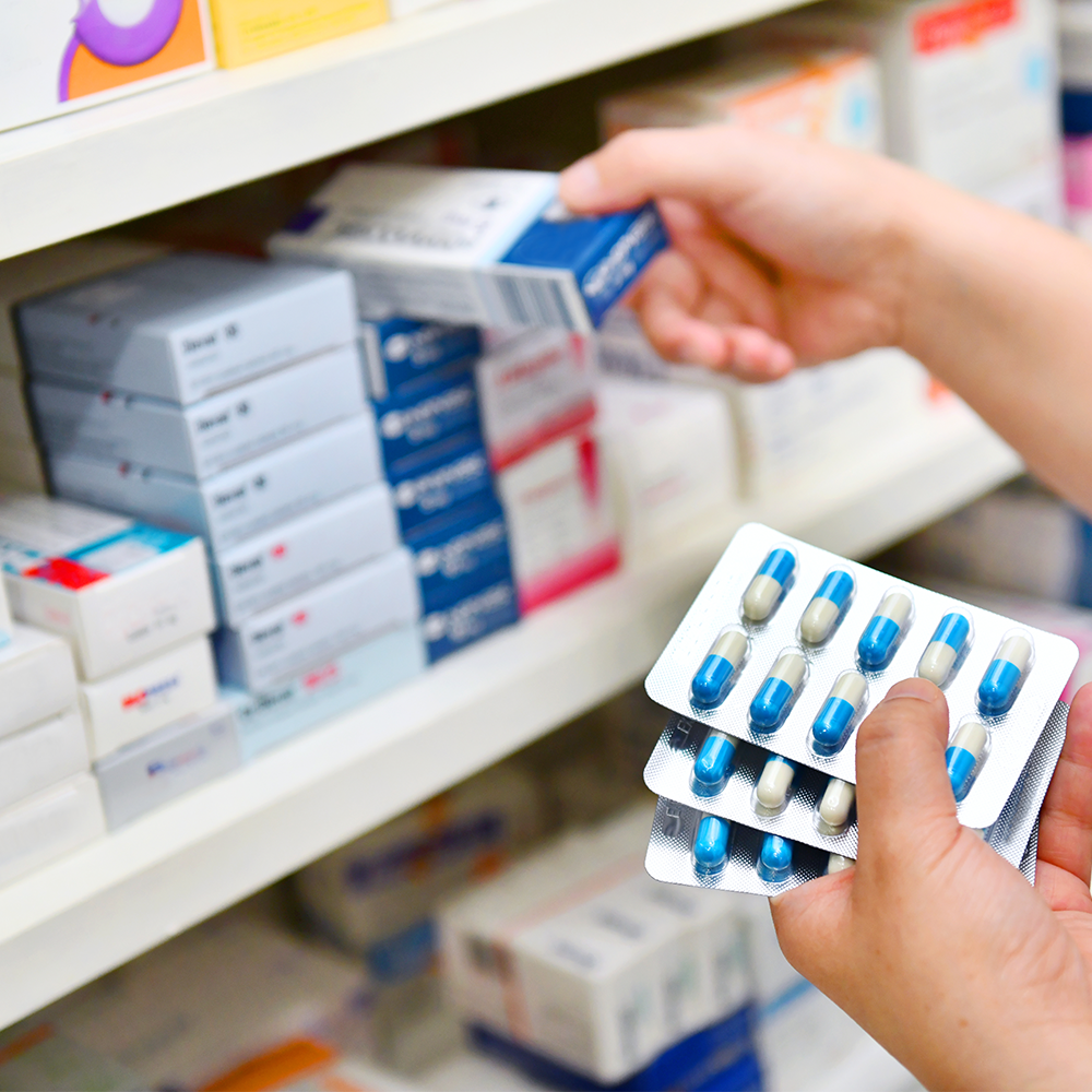 A pharmacist restocking medicine
